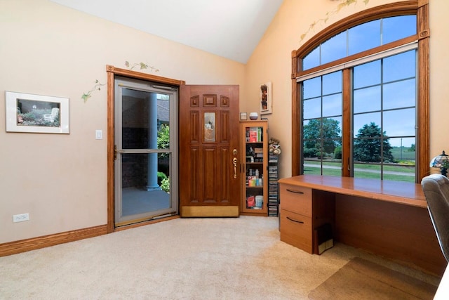 carpeted office space with vaulted ceiling