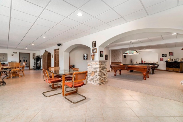 interior space with a paneled ceiling, light tile flooring, and pool table