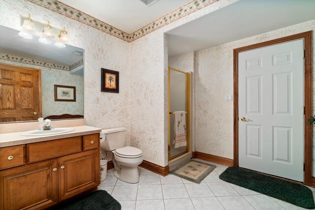 bathroom with vanity, tile flooring, a shower with door, and toilet