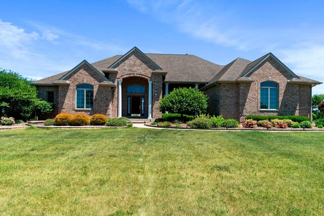 french country home featuring a front yard