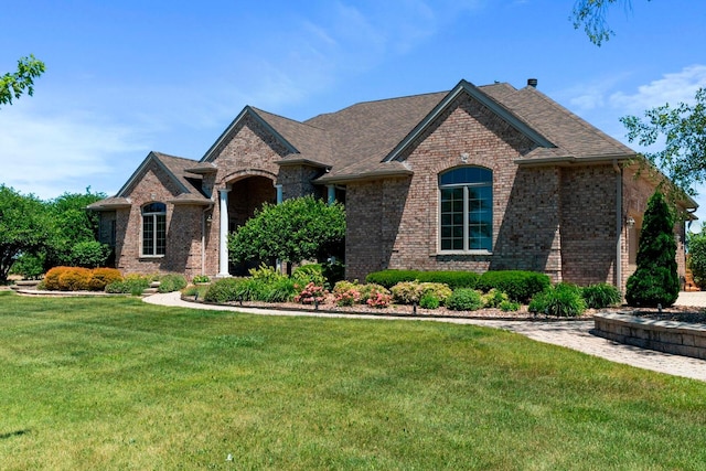 french provincial home with a front yard