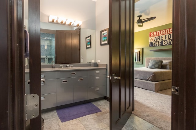 bathroom featuring ceiling fan, oversized vanity, and tile flooring