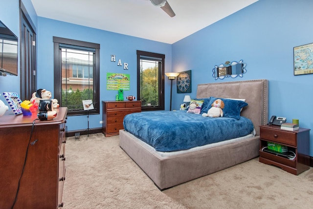 bedroom with light carpet and ceiling fan