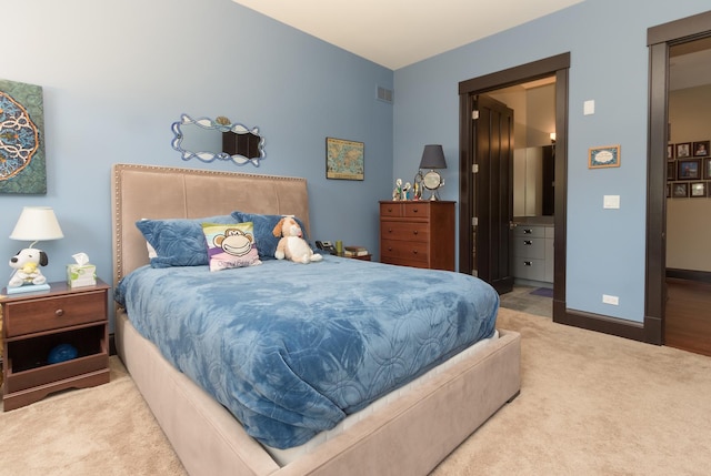 carpeted bedroom featuring ensuite bathroom