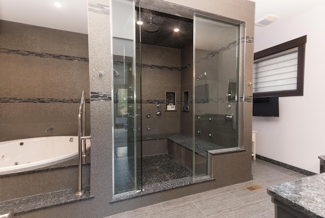 bathroom featuring tile flooring, plus walk in shower, and vanity