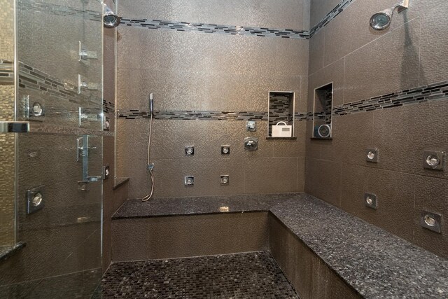 bathroom with tiled shower