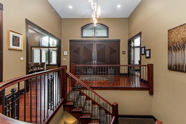 entryway with a towering ceiling and dark hardwood / wood-style floors