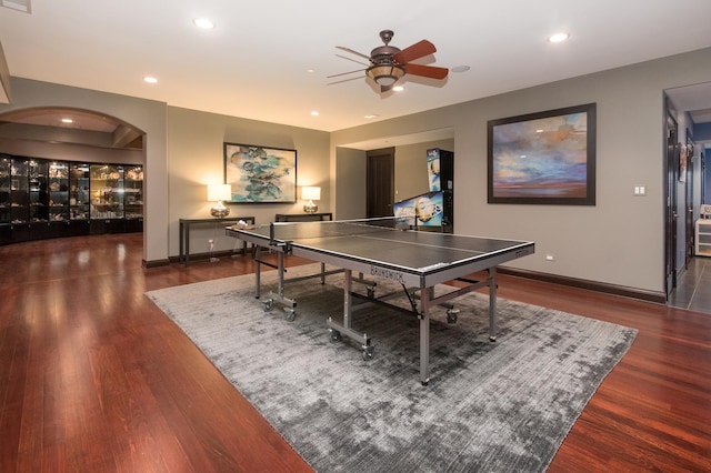 recreation room with ceiling fan and dark wood-type flooring