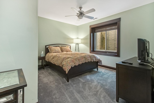 bedroom with dark colored carpet and ceiling fan