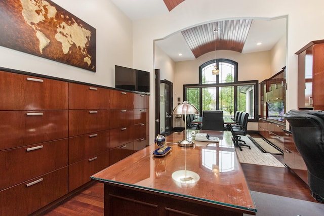 office featuring dark wood-type flooring and a high ceiling