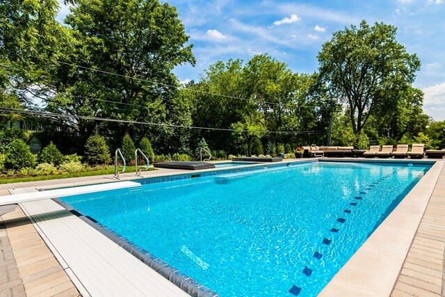 view of pool featuring a diving board