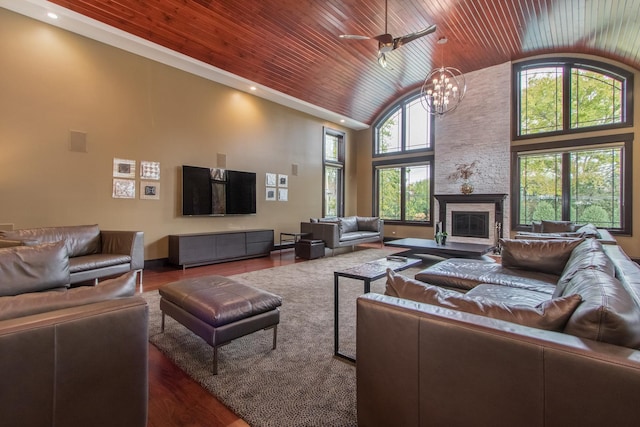 living room with wooden ceiling, high vaulted ceiling, a stone fireplace, and dark hardwood / wood-style flooring