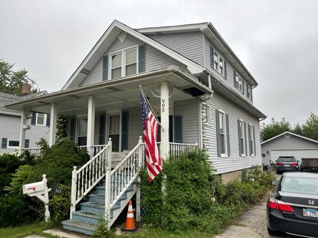 view of front of property featuring covered porch and a garage