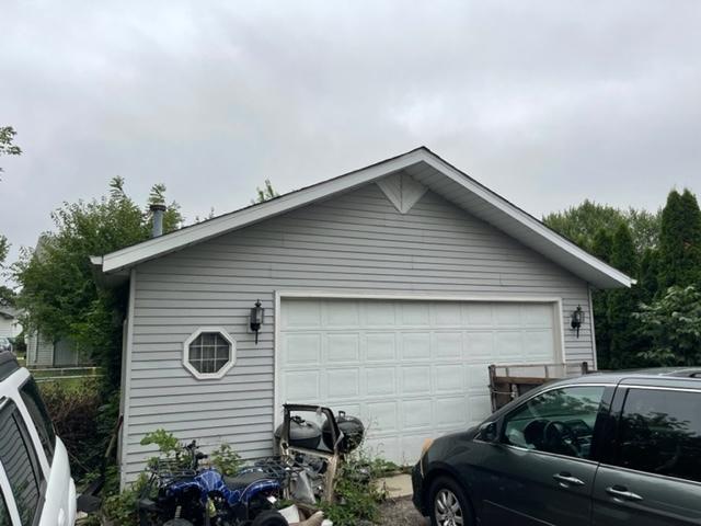 view of side of home with a garage