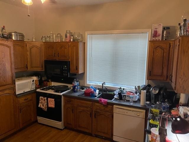 kitchen with ceiling fan, white appliances, sink, and hardwood / wood-style floors