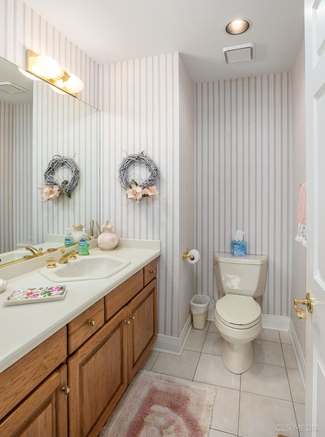 bathroom with tile flooring, toilet, and vanity with extensive cabinet space