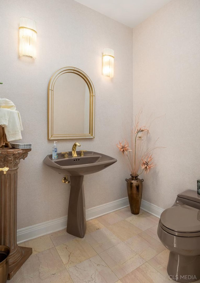 bathroom with toilet and tile floors