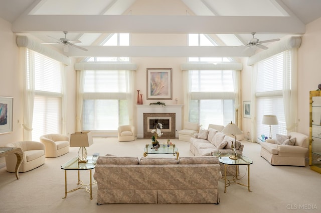 carpeted living room with high vaulted ceiling, ceiling fan, and beamed ceiling