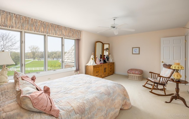 carpeted bedroom with ceiling fan and multiple windows