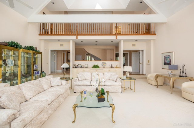 living room featuring light colored carpet, ceiling fan, and a high ceiling