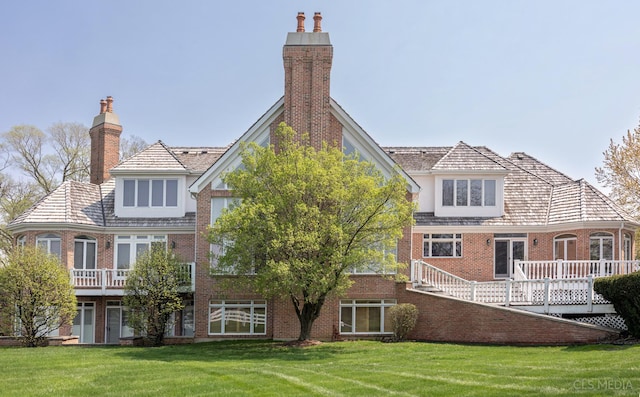 back of house with a wooden deck and a yard