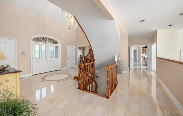 tiled entryway with an inviting chandelier