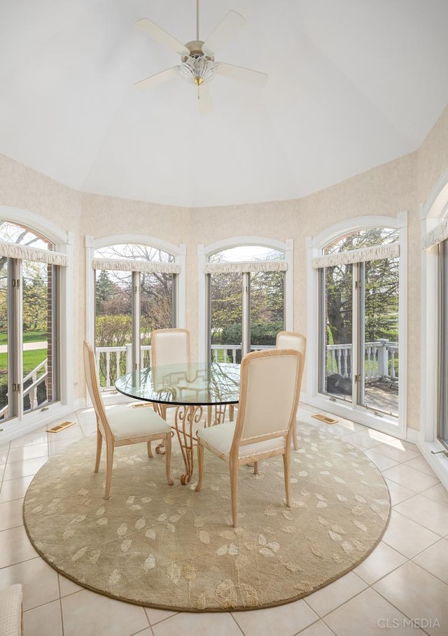 sunroom featuring lofted ceiling and ceiling fan