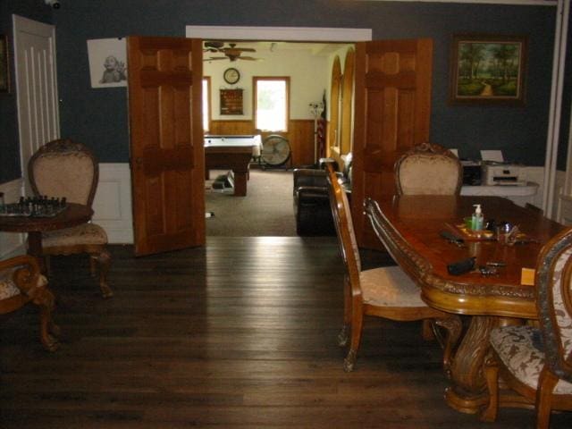 dining space featuring ceiling fan and dark hardwood / wood-style flooring