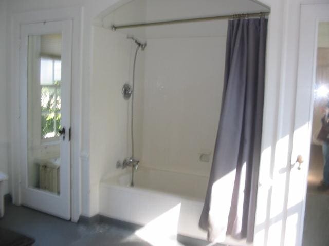 bathroom featuring shower / bathtub combination with curtain