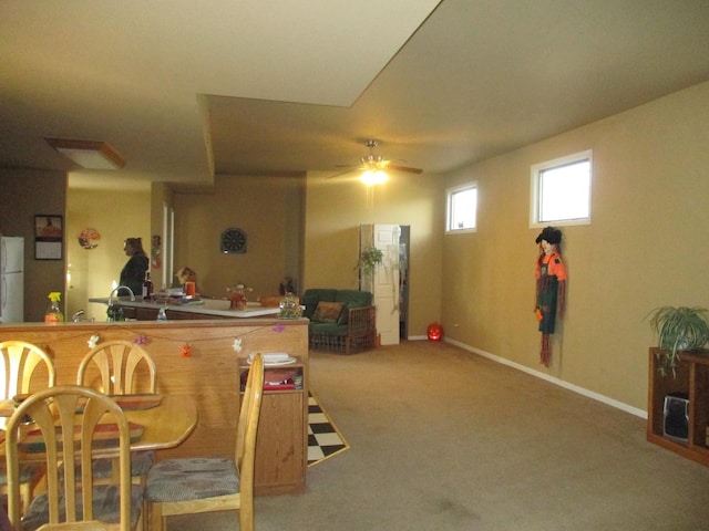 bar with carpet floors, ceiling fan, and white refrigerator