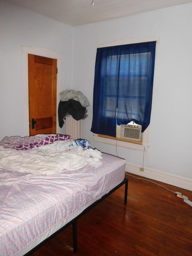 bedroom with dark wood-type flooring