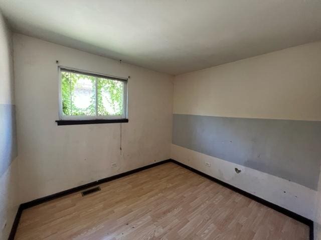 unfurnished room with light hardwood / wood-style flooring