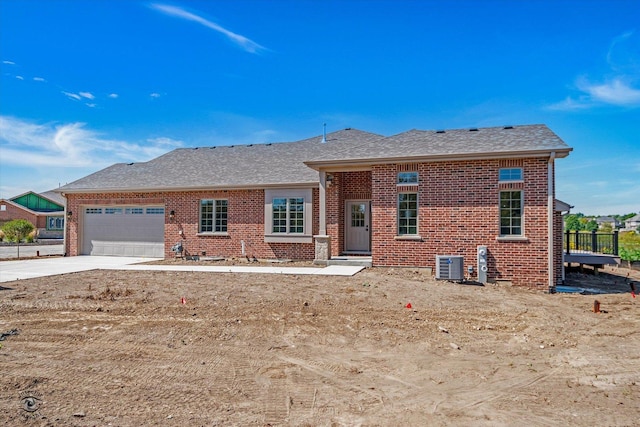 view of front of house with central AC and a garage