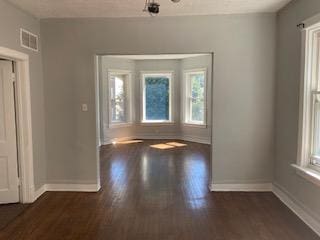 spare room with dark hardwood / wood-style flooring