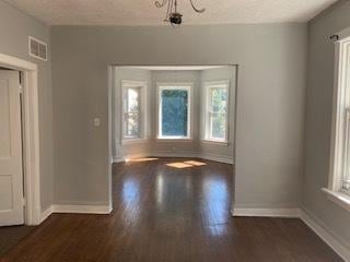 empty room with dark hardwood / wood-style floors