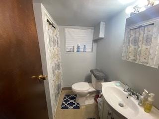 bathroom with toilet and large vanity