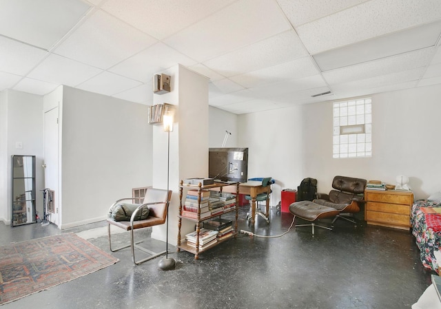 living room featuring a drop ceiling