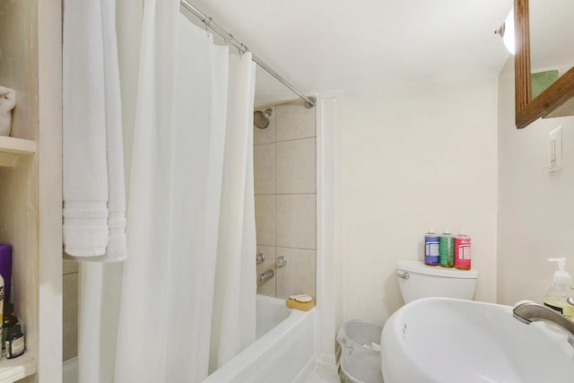 full bathroom featuring sink, shower / bath combination with curtain, and toilet