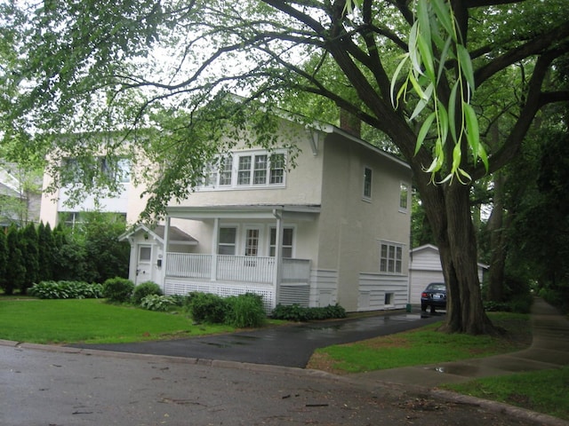 view of front property with a front yard and covered porch