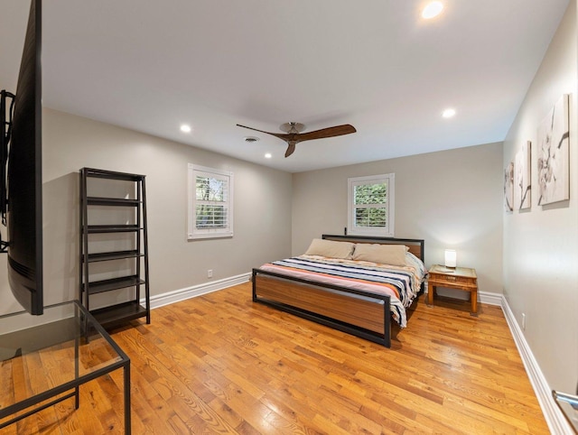 bedroom with ceiling fan and light hardwood / wood-style flooring