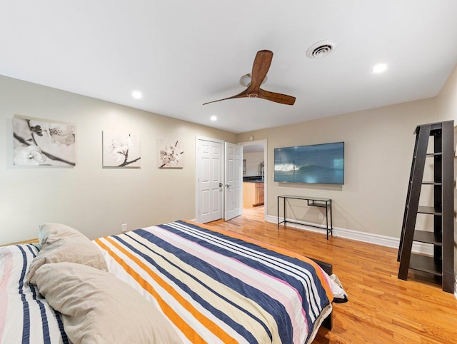 bedroom with ceiling fan, a closet, and light hardwood / wood-style flooring