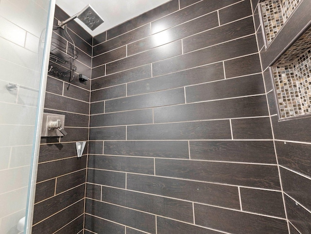 bathroom with a tile shower