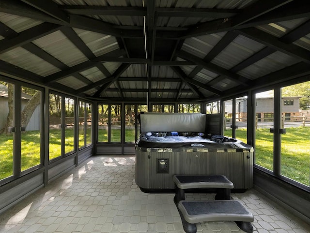 unfurnished sunroom with a wealth of natural light and lofted ceiling with beams