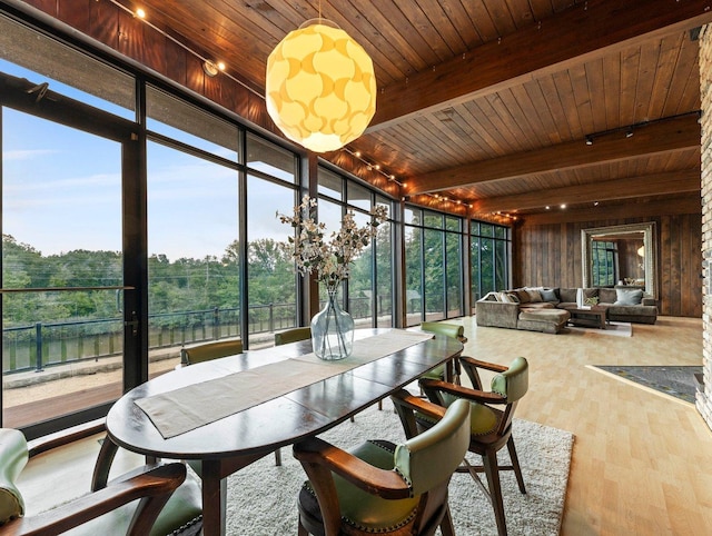 sunroom featuring track lighting, beamed ceiling, and wooden ceiling