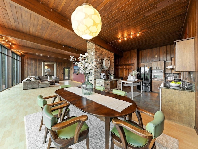 dining space with brick wall, wooden walls, wooden ceiling, and light hardwood / wood-style flooring