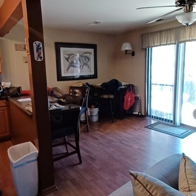 dining space with plenty of natural light, ceiling fan, and dark wood-type flooring