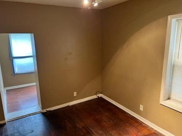 spare room featuring dark hardwood / wood-style flooring