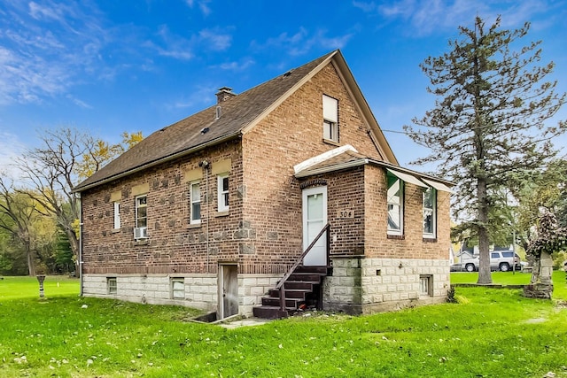 rear view of house with a yard