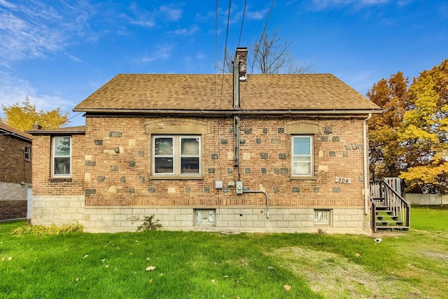 back of property featuring a yard