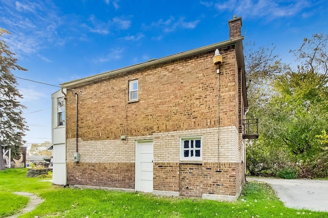 rear view of property featuring a lawn